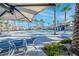 Inviting community pool area with palm trees and lounge chairs at 2843 Kona Blue Ln # 4, Las Vegas, NV 89183