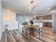 Open-concept dining area with stylish lighting and a view into the modern kitchen at 2843 Kona Blue Ln # 4, Las Vegas, NV 89183