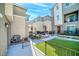 Backyard patio area with synthetic grass and a small seating area at 2843 Kona Blue Ln # 4, Las Vegas, NV 89183