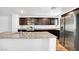 Modern kitchen with granite countertops, stainless appliances, and dark wood cabinetry at 2843 Kona Blue Ln # 4, Las Vegas, NV 89183