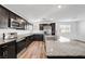 Bright kitchen with stainless steel appliances, granite counters, and dark wood cabinets at 2843 Kona Blue Ln # 4, Las Vegas, NV 89183