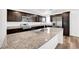 Spacious kitchen features granite countertops, dark cabinets, and stainless steel appliances at 2843 Kona Blue Ln # 4, Las Vegas, NV 89183