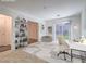 Bright living room with a work station, shelves, and a sliding glass door at 2843 Kona Blue Ln # 4, Las Vegas, NV 89183