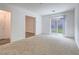 Bright living room featuring a sliding glass door and neutral carpet at 2843 Kona Blue Ln # 4, Las Vegas, NV 89183