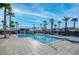 Relaxing community pool with palm trees, lounge chairs, and a clear blue sky at 2843 Kona Blue Ln # 4, Las Vegas, NV 89183