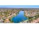 Gorgeous aerial view of a lakeside community with lush landscaping and stunning mountain views on the horizon at 3125 N Buffalo Dr # 1133, Las Vegas, NV 89128