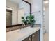 Bathroom featuring a modern vanity with granite countertop, decorative mirror, and tiled shower and walk-in closet at 3125 N Buffalo Dr # 1133, Las Vegas, NV 89128