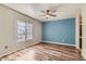 Bedroom with wood floors, blue accent wall, and natural light from the large windows and ceiling fan at 3125 N Buffalo Dr # 1133, Las Vegas, NV 89128