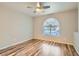 Bedroom with wood-look floors, ceiling fan and arched window with privacy blinds at 3125 N Buffalo Dr # 1133, Las Vegas, NV 89128