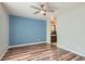 Cozy bedroom featuring wood flooring, a ceiling fan, and an ensuite bathroom for added privacy and convenience at 3125 N Buffalo Dr # 1133, Las Vegas, NV 89128