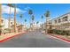Entrance view of a condo community with palm trees and signage reading Mar-A-Lago, A Desert Shores Community at 3125 N Buffalo Dr # 1133, Las Vegas, NV 89128