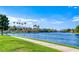 Beautiful waterfront view of the lake with sidewalks and green grass, perfect for walking and enjoying outdoors at 3125 N Buffalo Dr # 1133, Las Vegas, NV 89128