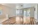 Bright and airy living room featuring wood floors and sliding glass door at 3125 N Buffalo Dr # 1133, Las Vegas, NV 89128