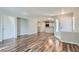 Open-concept living room showcasing wood floors and seamless flow into kitchen at 3125 N Buffalo Dr # 1133, Las Vegas, NV 89128