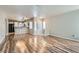 Open-concept living room showcasing wood floors and seamless flow into kitchen at 3125 N Buffalo Dr # 1133, Las Vegas, NV 89128