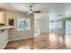 Bright living room with wood floors, neutral walls, ceiling fan, and access to a balcony for indoor/outdoor living at 3125 N Buffalo Dr # 1133, Las Vegas, NV 89128