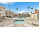 Community pool and hot tub surrounded by palm trees, lounge chairs, and well-maintained landscaping at 3125 N Buffalo Dr # 1133, Las Vegas, NV 89128