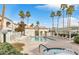 Community pool and hot tub surrounded by lounge chairs and palm trees creating a relaxing atmosphere at 3125 N Buffalo Dr # 1133, Las Vegas, NV 89128