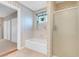 Bright bathroom featuring a tub, shower, and plant near the window at 3200 Bryant Ave, Las Vegas, NV 89102