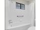 Clean bathroom with white tile and tub and shower fixture and curtain at 3200 Bryant Ave, Las Vegas, NV 89102