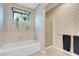 Bathroom featuring a bathtub, shower, and large window at 3200 Bryant Ave, Las Vegas, NV 89102