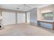 A spacious bedroom includes a vanity, a ceiling fan, and plentiful natural light at 3200 Bryant Ave, Las Vegas, NV 89102