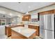 Charming kitchen featuring an island, stainless steel refrigerator, and wooden cabinets at 3200 Bryant Ave, Las Vegas, NV 89102