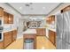 Bright kitchen with an island, wooden cabinets, stainless steel appliances, and hardwood floors at 3200 Bryant Ave, Las Vegas, NV 89102