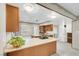 A kitchen featuring wooden cabinetry, a speckled countertop, and an island with cooktop at 3200 Bryant Ave, Las Vegas, NV 89102