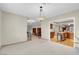 Open floor plan living room, leading to the kitchen with an island and wood cabinets at 3200 Bryant Ave, Las Vegas, NV 89102