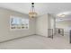 Living room featuring neutral tones, modern lighting fixture, and decorative railings at 3200 Bryant Ave, Las Vegas, NV 89102