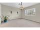 Living room featuring neutral tones, modern lighting fixture, and large window at 3200 Bryant Ave, Las Vegas, NV 89102