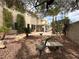 Landscaped backyard with stone walkway, mature trees, and covered patio at 3340 Shallow Pond Dr, Las Vegas, NV 89117