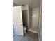 Bathroom featuring a walk-in shower with marble-style tiles and wood-look flooring at 3340 Shallow Pond Dr, Las Vegas, NV 89117