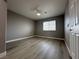Bedroom with wood-look flooring, ceiling fan, and ample natural light at 3340 Shallow Pond Dr, Las Vegas, NV 89117