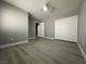 This bedroom features wood flooring, a ceiling fan, and a spacious closet at 3340 Shallow Pond Dr, Las Vegas, NV 89117