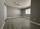 This bedroom features wood flooring, a ceiling fan, and a spacious closet at 3340 Shallow Pond Dr, Las Vegas, NV 89117