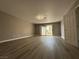 Updated bedroom with laminate flooring, neutral paint, recessed lights, and sliding glass door at 3340 Shallow Pond Dr, Las Vegas, NV 89117