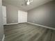 Empty bedroom with new flooring, closet, and base trim at 3340 Shallow Pond Dr, Las Vegas, NV 89117
