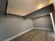 Walk-in closet with laminate flooring and shelving at 3340 Shallow Pond Dr, Las Vegas, NV 89117
