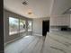 Bright dining area with large windows, new flooring, and modern light fixture at 3340 Shallow Pond Dr, Las Vegas, NV 89117