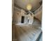 Grand entryway with curved staircase, modern flooring, and decorative chandelier at 3340 Shallow Pond Dr, Las Vegas, NV 89117