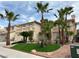 Beautiful two-story home featuring desert landscaping with palm trees and green turf at 3340 Shallow Pond Dr, Las Vegas, NV 89117