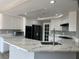 Modern kitchen featuring stainless appliances, stone countertops, and white cabinetry at 3340 Shallow Pond Dr, Las Vegas, NV 89117