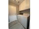 Well-lit laundry room features white cabinets, washer, and dryer hookups at 3340 Shallow Pond Dr, Las Vegas, NV 89117