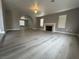 Spacious living room with fireplace, modern flooring, and an arched doorway at 3340 Shallow Pond Dr, Las Vegas, NV 89117