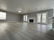 Spacious living room featuring new flooring, fireplace and French doors to backyard at 3340 Shallow Pond Dr, Las Vegas, NV 89117