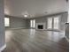 Large living room with new flooring, fireplace and French doors to backyard at 3340 Shallow Pond Dr, Las Vegas, NV 89117