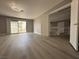 Bright living room featuring wood floors and large glass sliding doors to the outdoor area at 3340 Shallow Pond Dr, Las Vegas, NV 89117