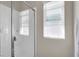 Bright bathroom showcases a clean white shower with glass door and a window, combining style and functionality at 4625 Ridgeley Ave # 102, North Las Vegas, NV 89084